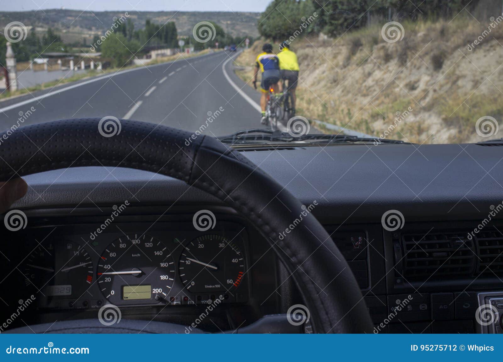 driving slowly behind cyclists at local road