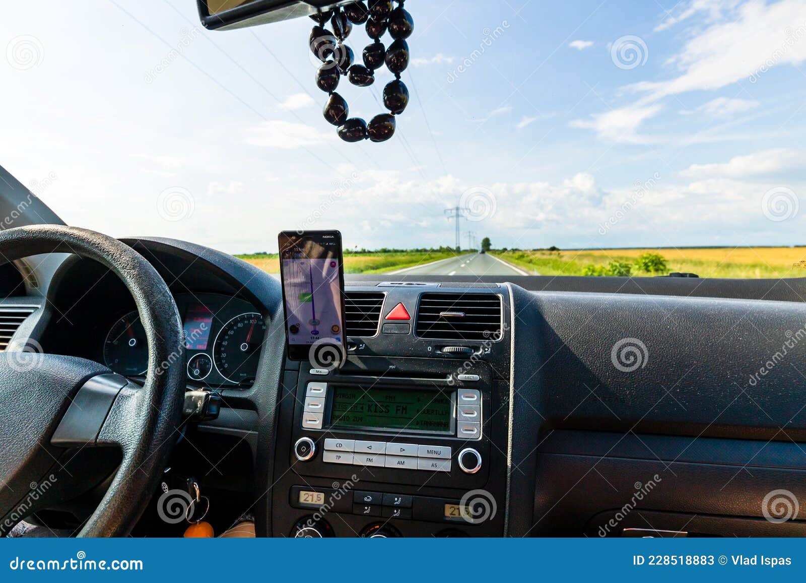Driving and Using Waze Maps Application on Smartphone on Car Dashboard