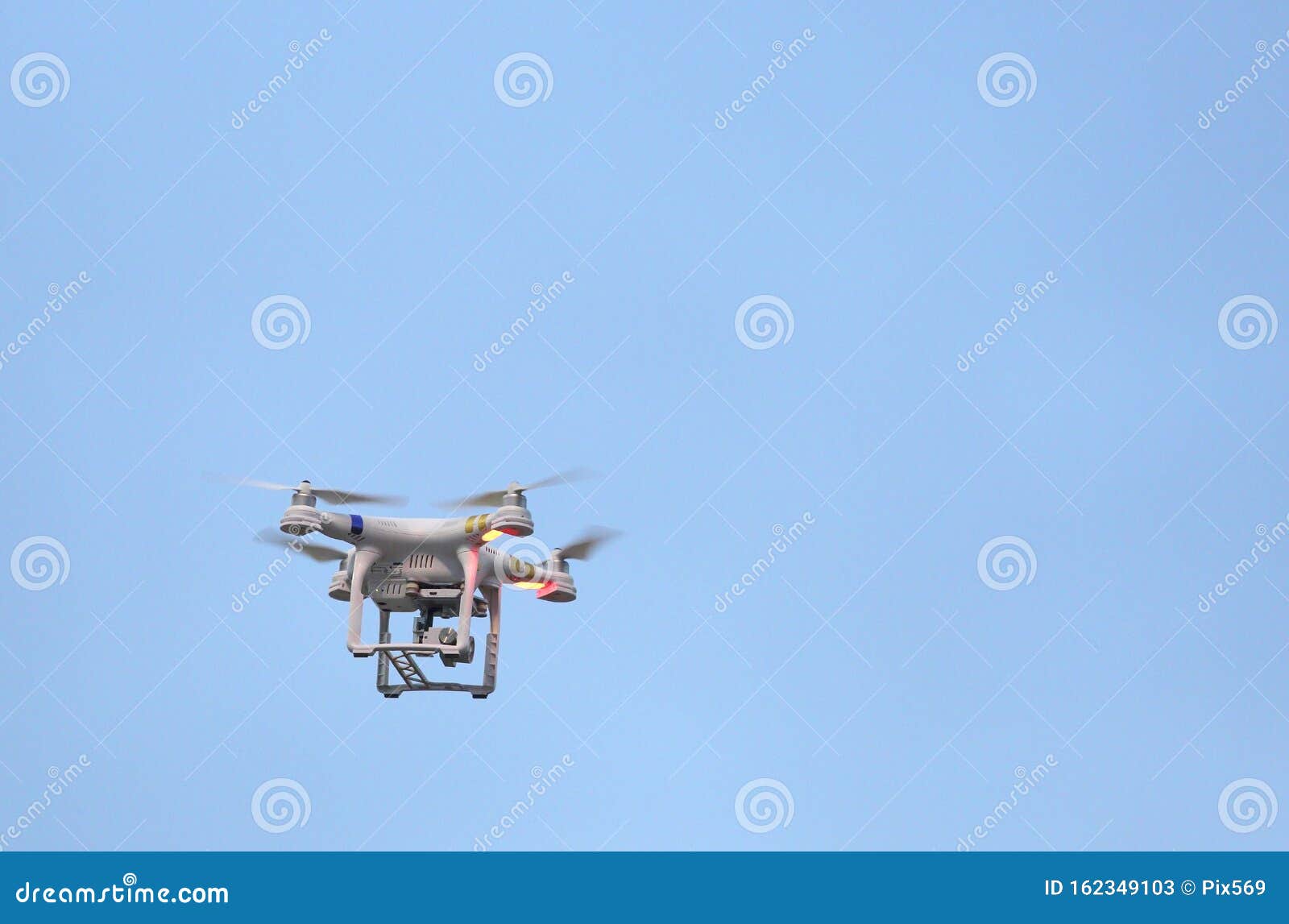 A Drone in Flight, Carrying a Camera. Stock Image Image of remote
