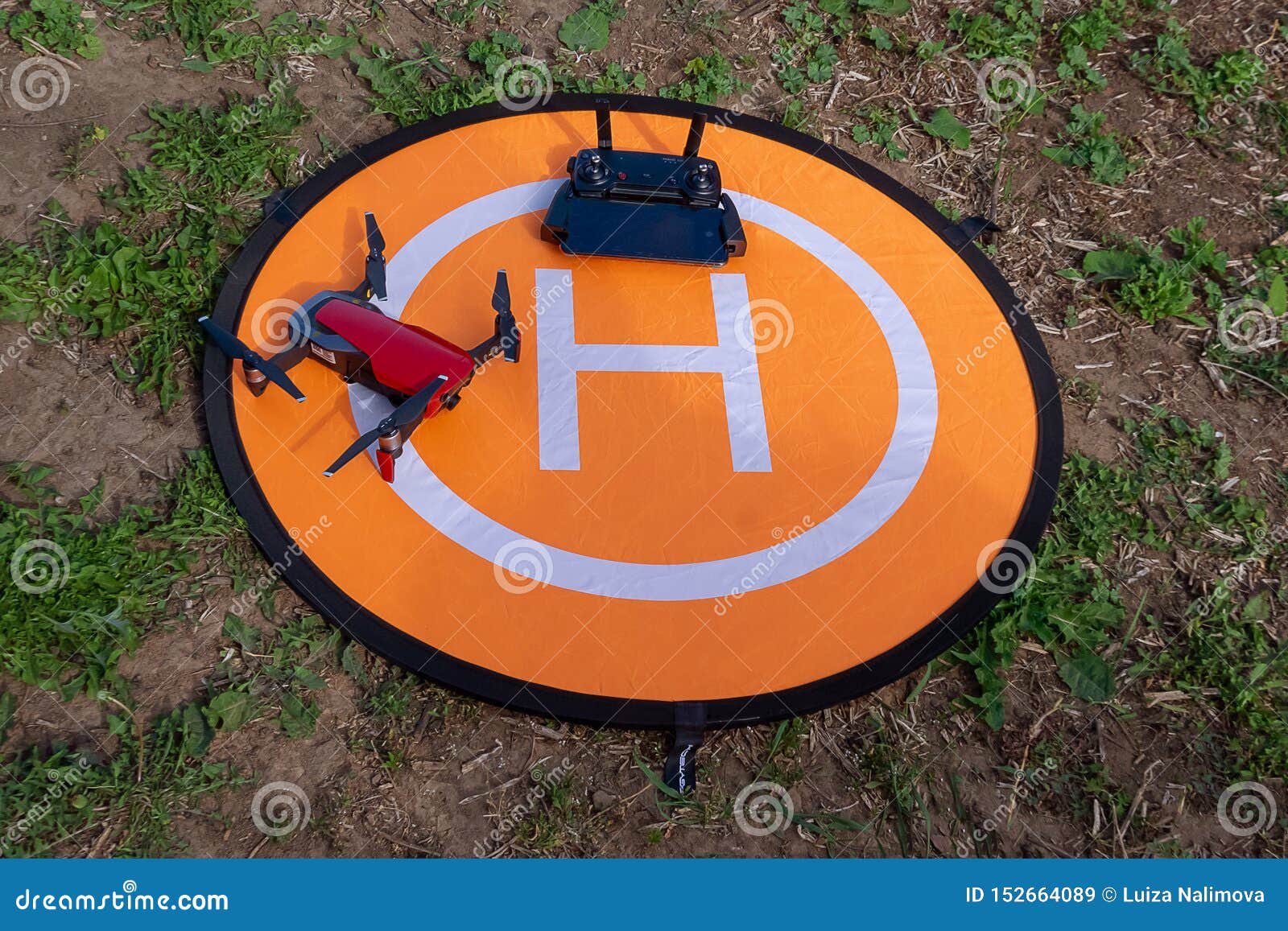 mestre analog dæmning Drone on the Heliport. Drone Phone and Control Panel on an Orange Helipad  on the Grass Editorial Stock Image - Image of camera, radio: 152664089
