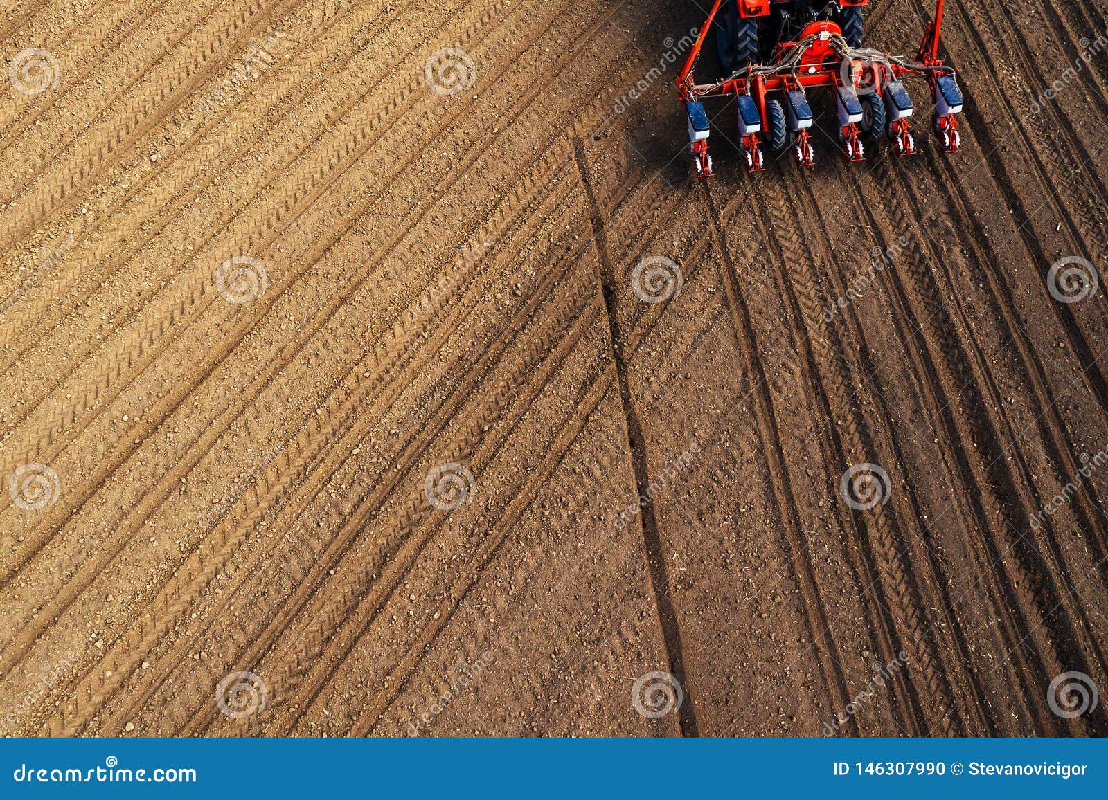 drone pov tractor sowing corn in field