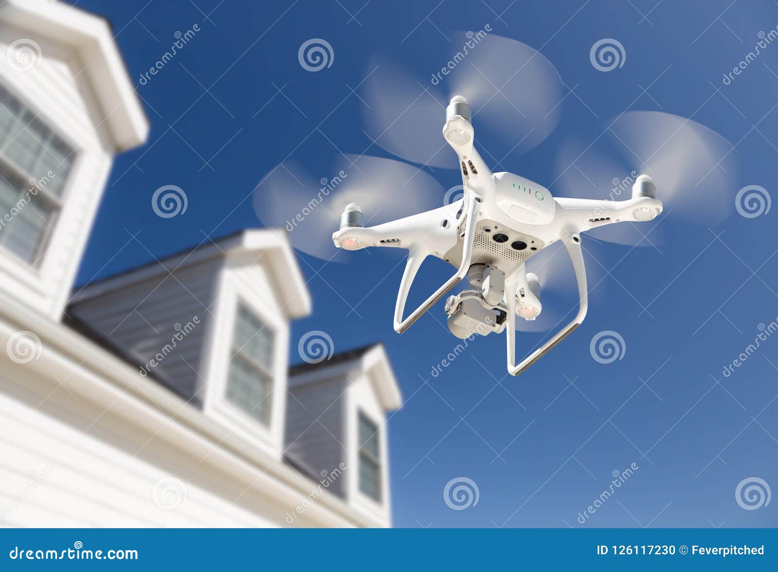 drone quadcopter flying, inspecting and photographing house
