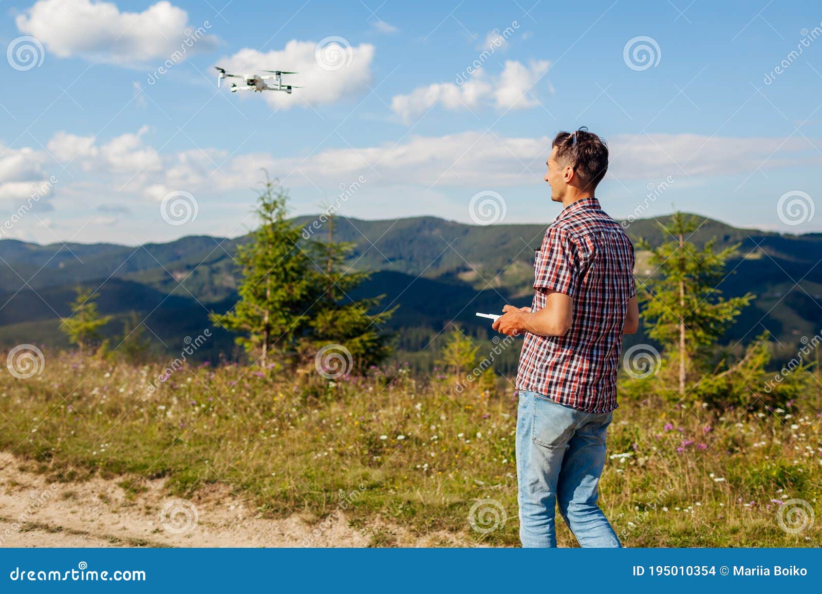 drone remote control. man operating copter controller in mountains. aerial video shooting of summer carpathins