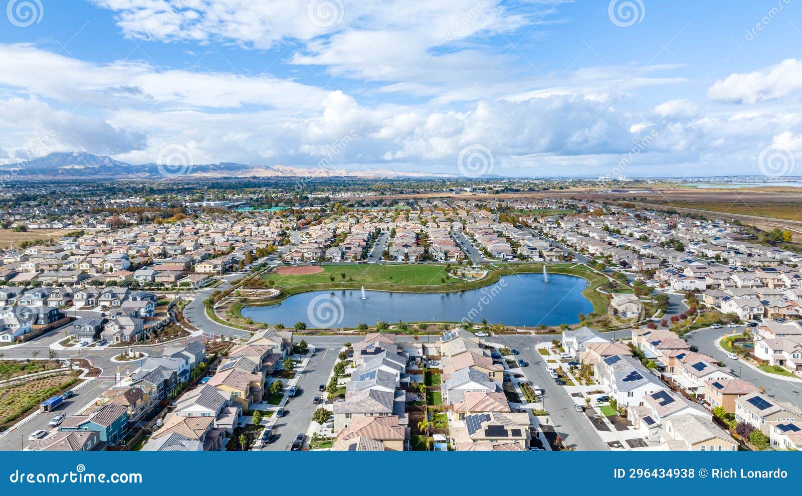 a drone view of a community in oakley, california with a lake in the center