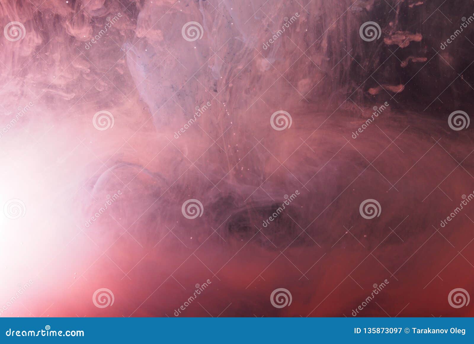 A Drop of Paint Dissolves in Water. Red Paint is Mixed with Water Stock