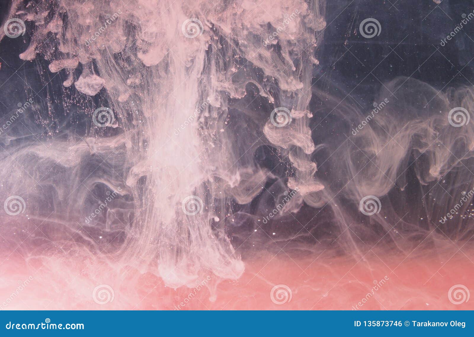 A Drop of Paint Dissolves in Water. Red Paint is Mixed with Water Stock