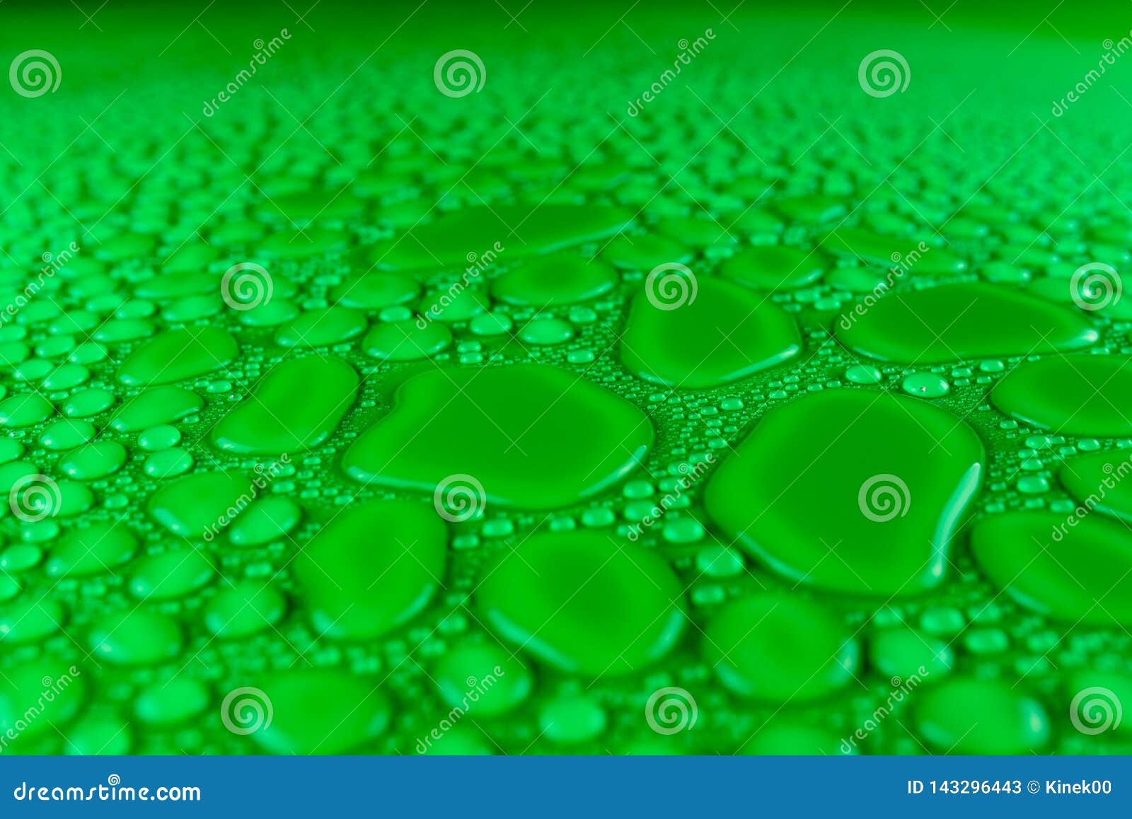 Droplets of Water on a Green, Matte Background Illuminated with a