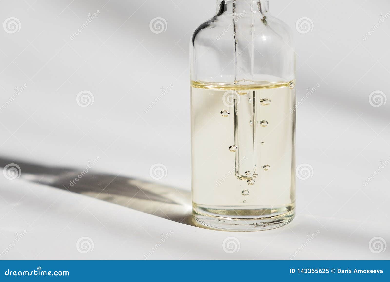 dropper glass bottle mock-up. cosmetic pipette on white background. oil bubbles.