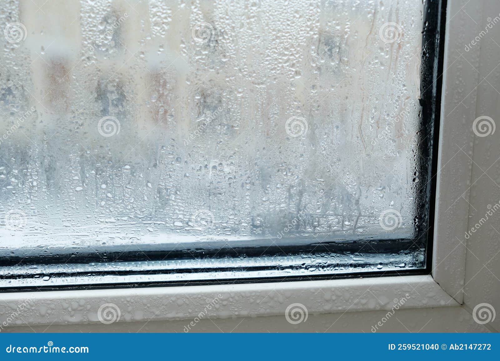 drops and condensation on the window. fogged window, fragment plastic frame, close-up. increased humidity in the apartment. poor