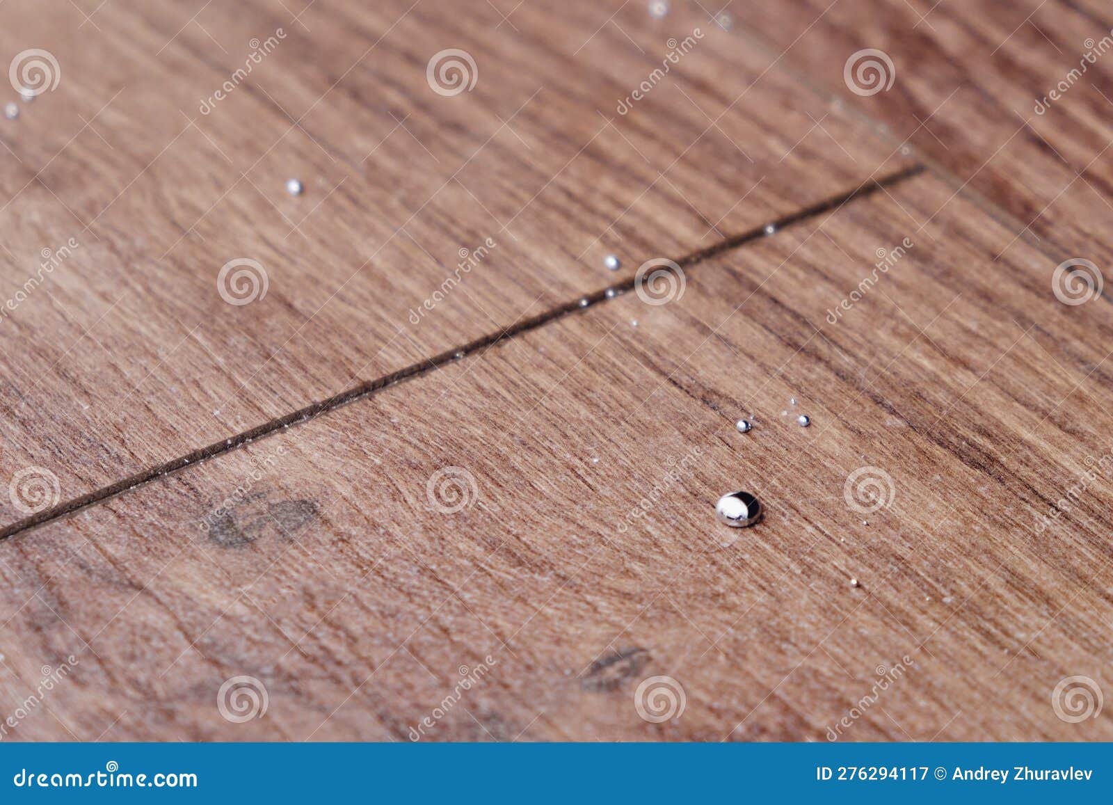 Drops of Mercury on the Floor from a Broken Thermometer. Liquid Meta