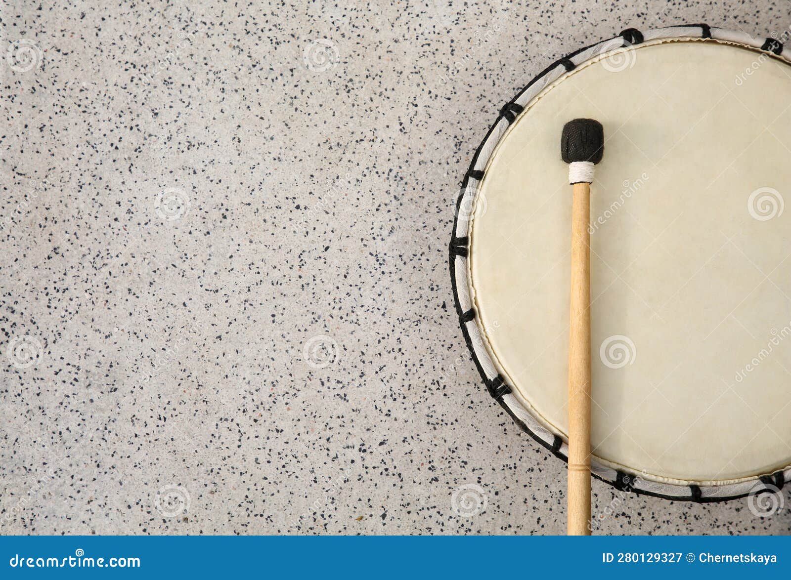 Drum and Drumstick on Grey Table, Top View with Space for Text