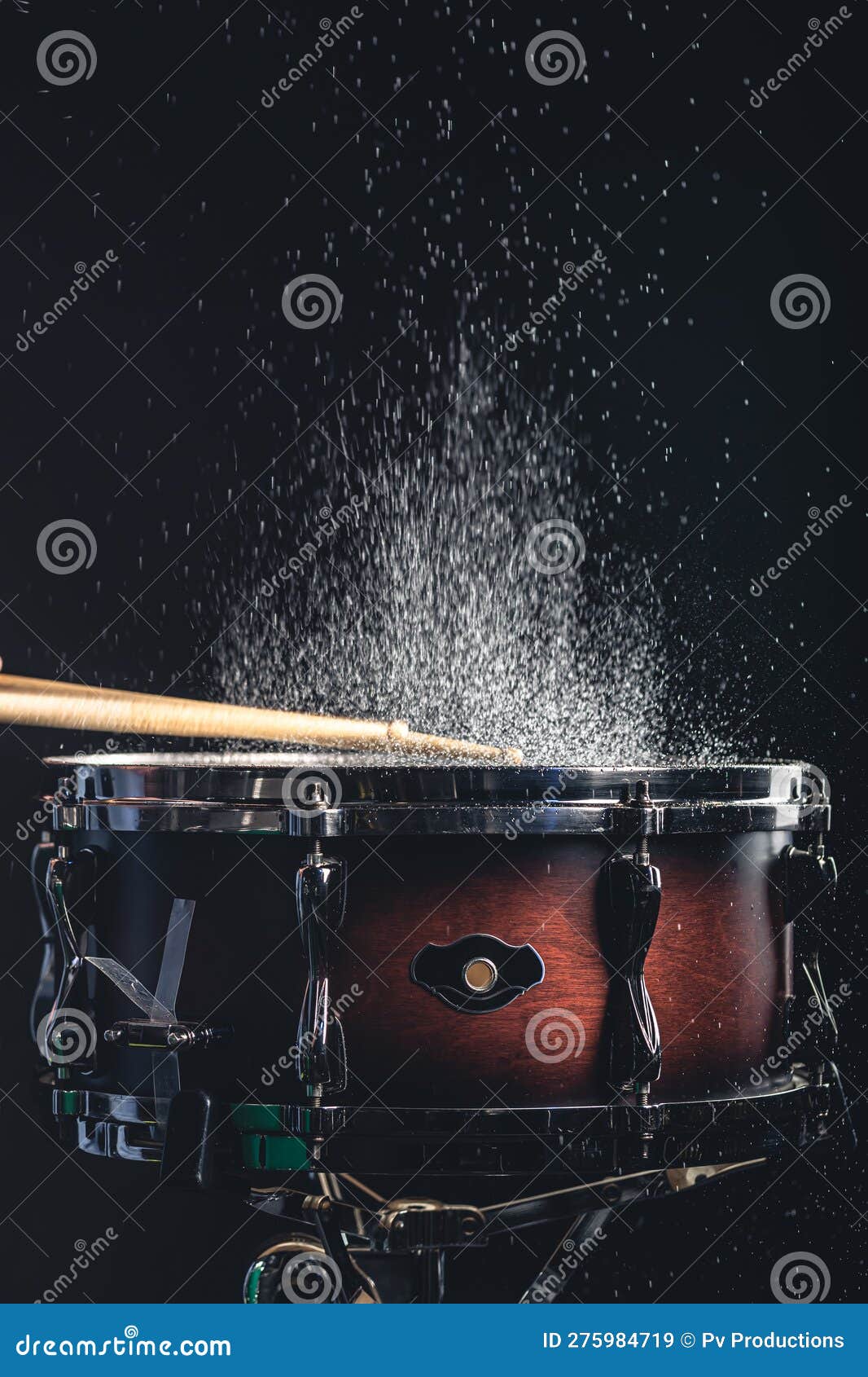 Drummer Using Drum Sticks Hitting Snare Drum with Splashing Water