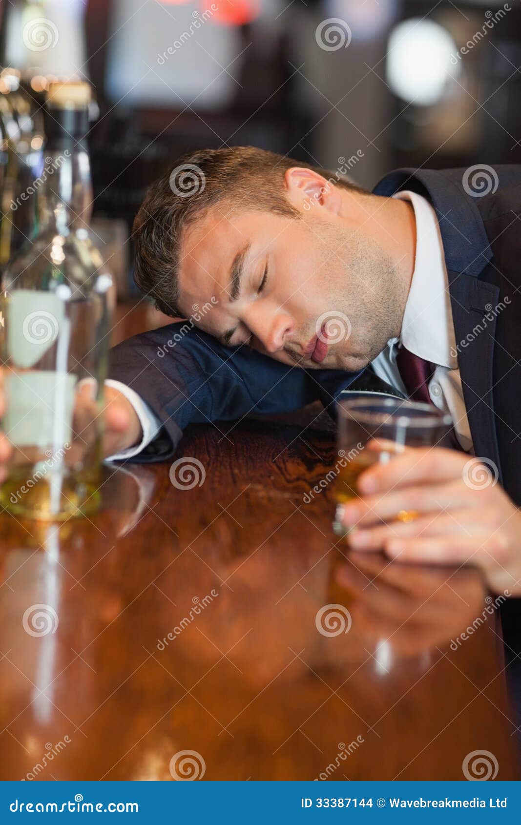 Drunk Businessman Holding Whiskey Glass Lying on a Counter Stock Photo ...