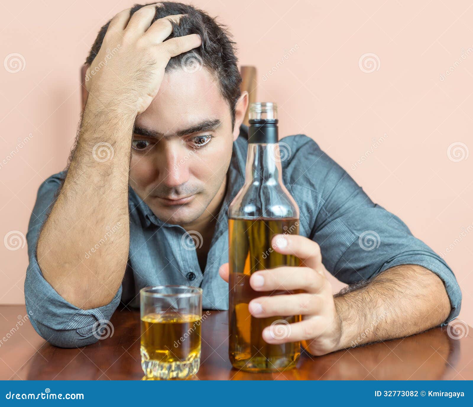 Drunk and Depressed Hispanic Man Suffering a Headache Stock Photo