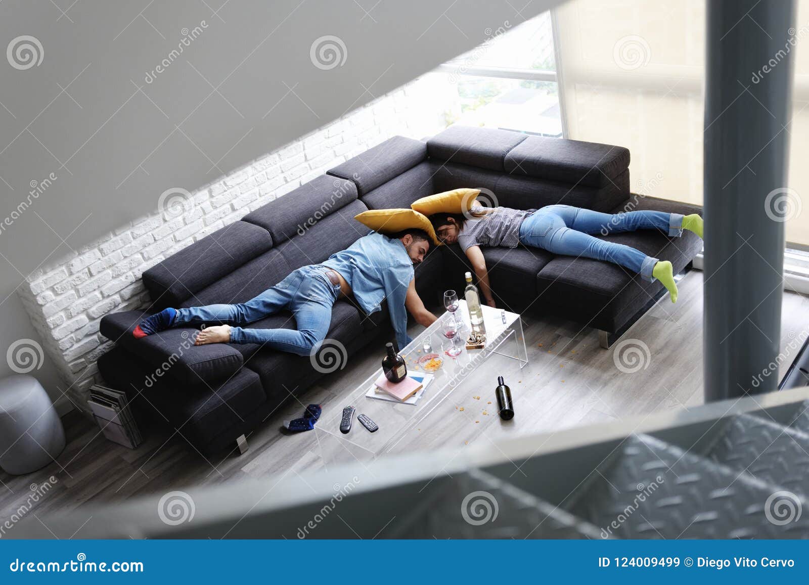 Drunk Friends Sleeping On Sofa In Messy Room After Party Stock Image 