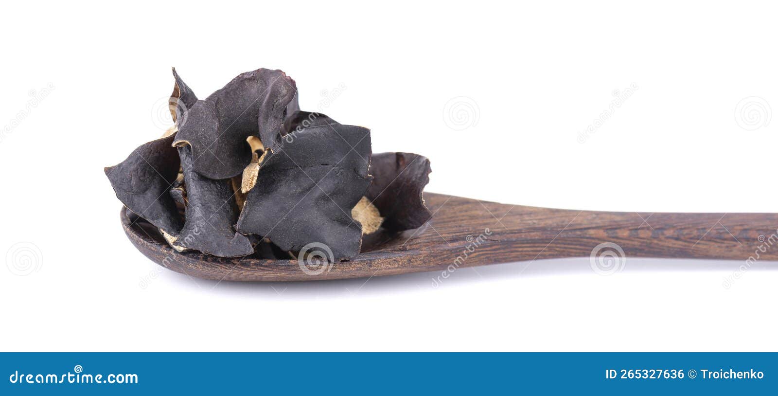 dry black fungus in wooden spoon,  on white background. chinese black mushroom or tree black muer mushroom