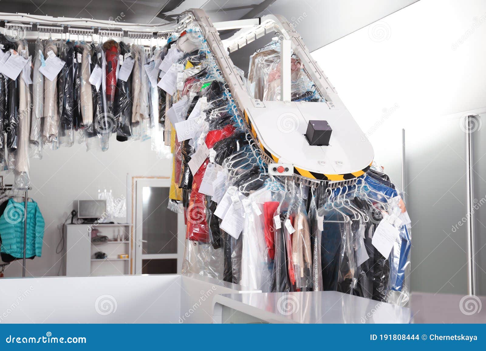 Hangers With Clothes On Garment Conveyor At Dry-cleaner's Stock Photo,  Picture and Royalty Free Image. Image 198000170.