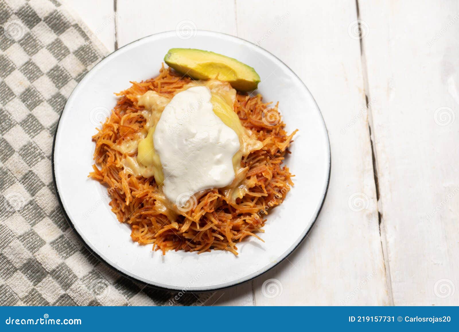 dry fideo with cheese and sour cream on white background