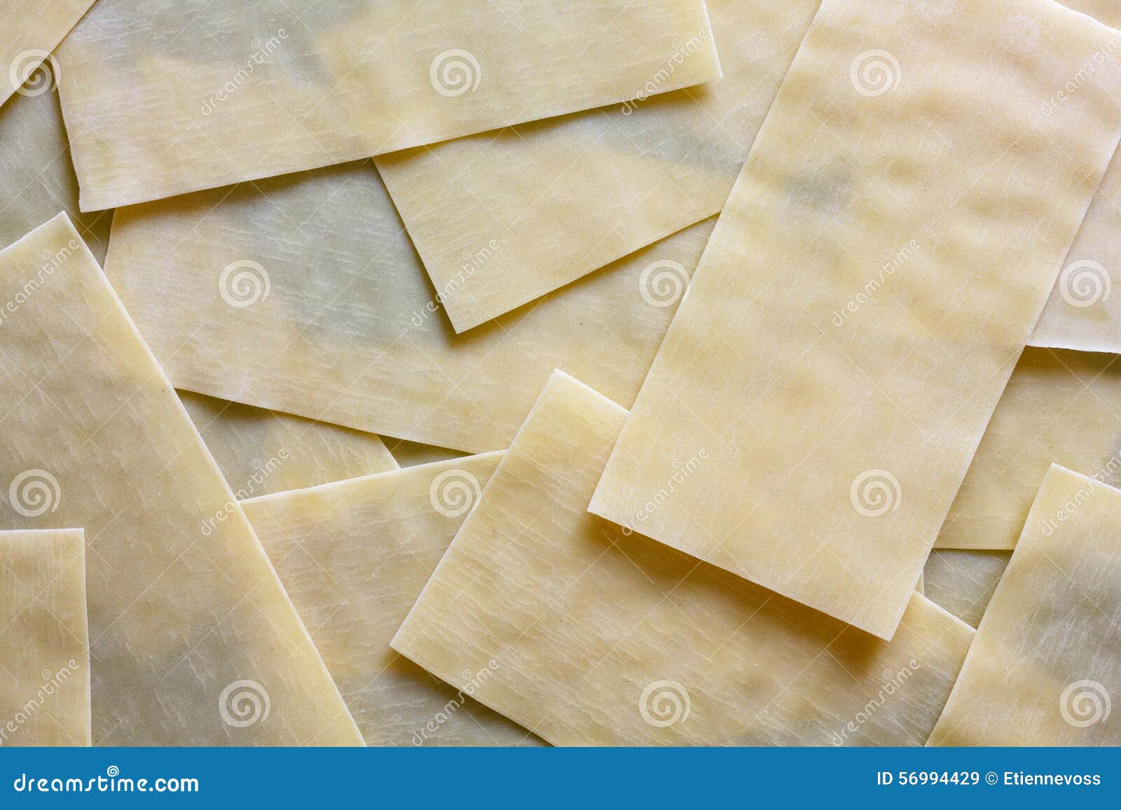 Dry Lasagna Pasta Sheets on Black Textured Wood from Above. Abst Stock