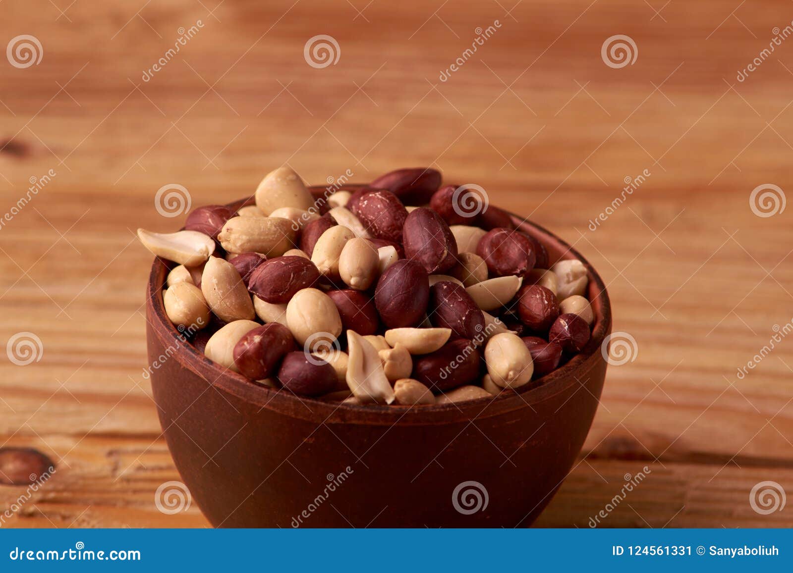 dry peanuts background. close up dry peanuts in clay bowl. space for pext. copyspace