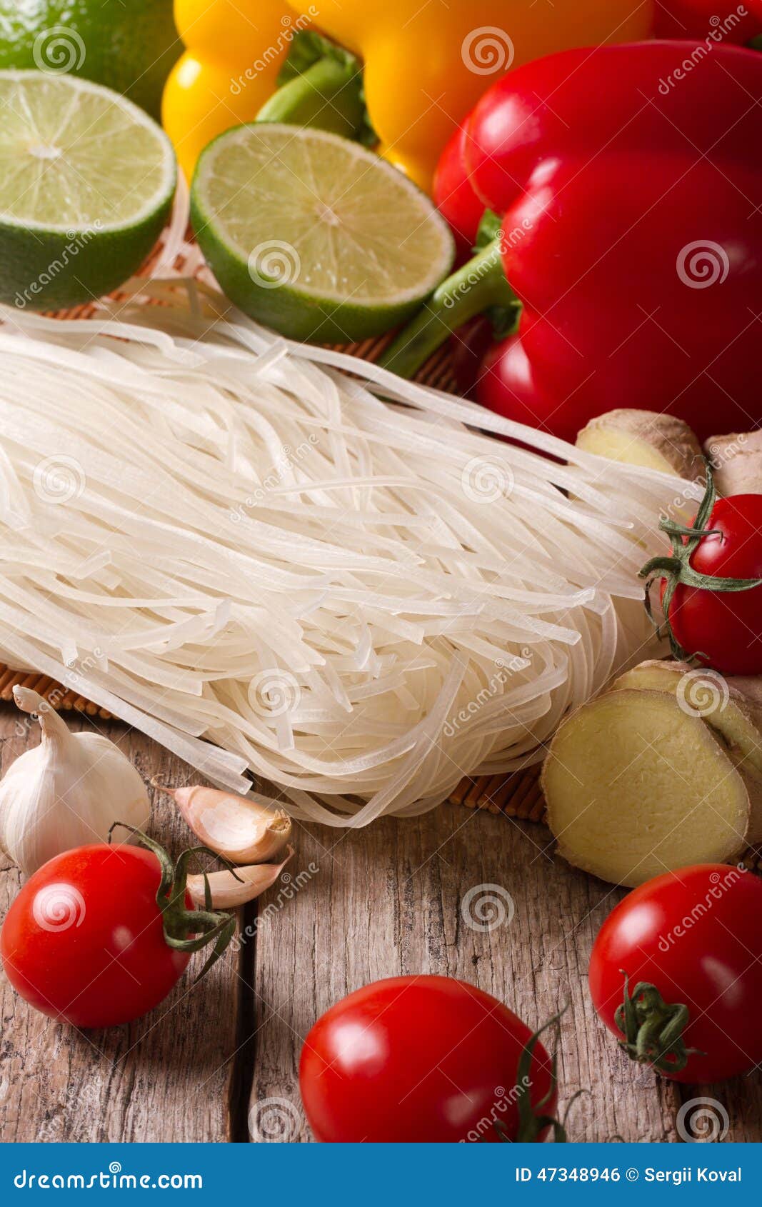 Dry Rice Noodles with Fresh Vegetables on a Table Vertical Stock Photo