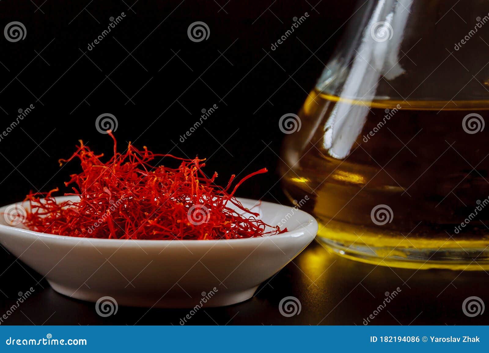 dry saffron on a white plate on black background