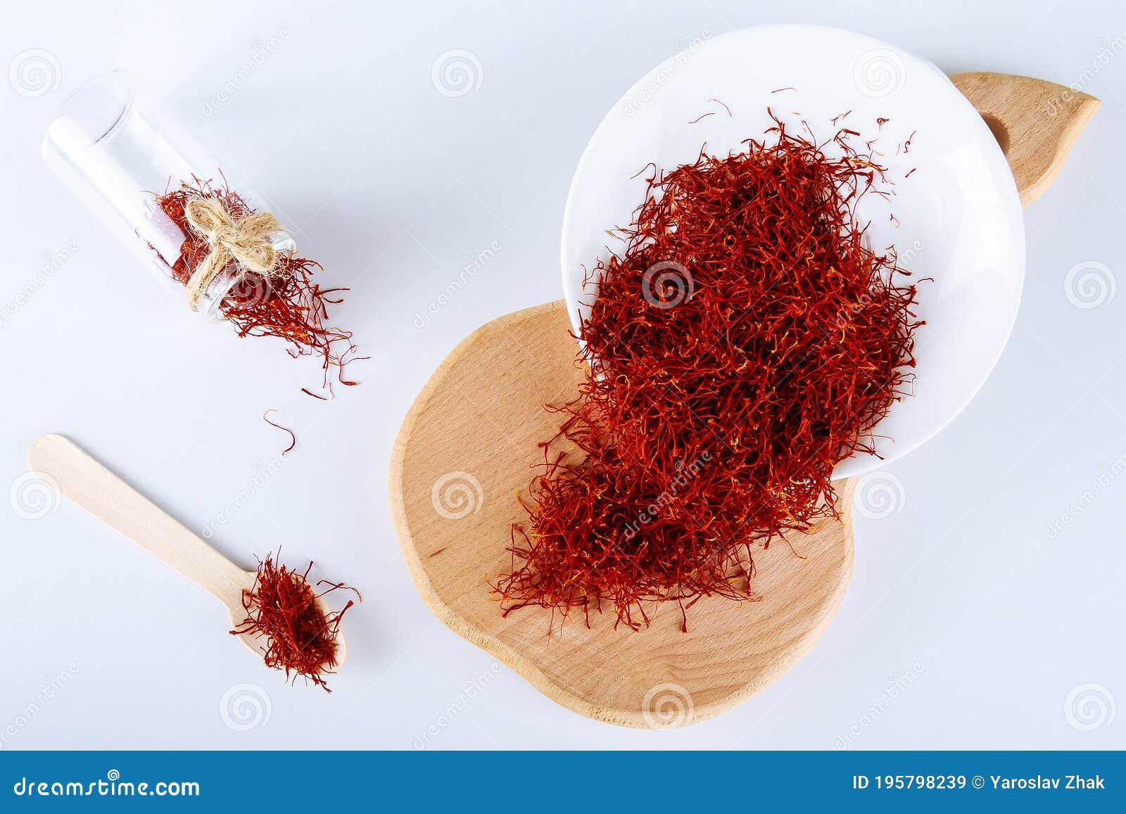 dry saffron spice on plate on white background. wooden board. the use of saffron in cooking, medicine, cosmetology