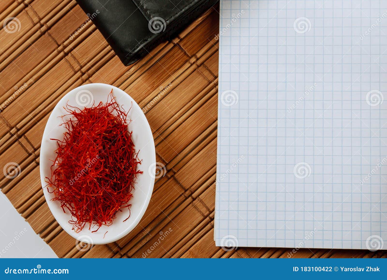 dry saffron spice on a white plate on wooden background. copy space