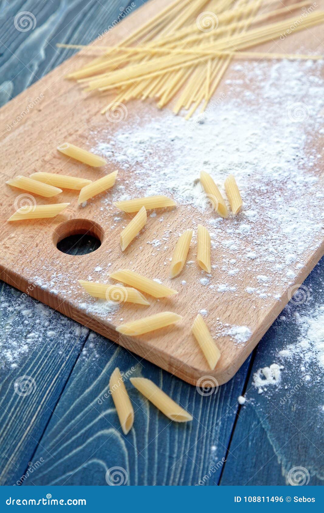 Dry Spaghetti and Pasta on on a Flourpadded Cutting Board. Stock Photo Image of board