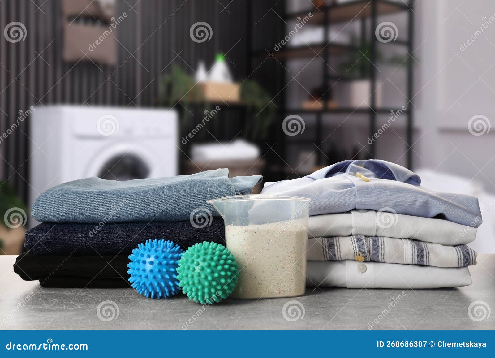 Dryer Balls, Detergent and Stacked Clean Clothes on Table in Laundry Room Stock Image Image of