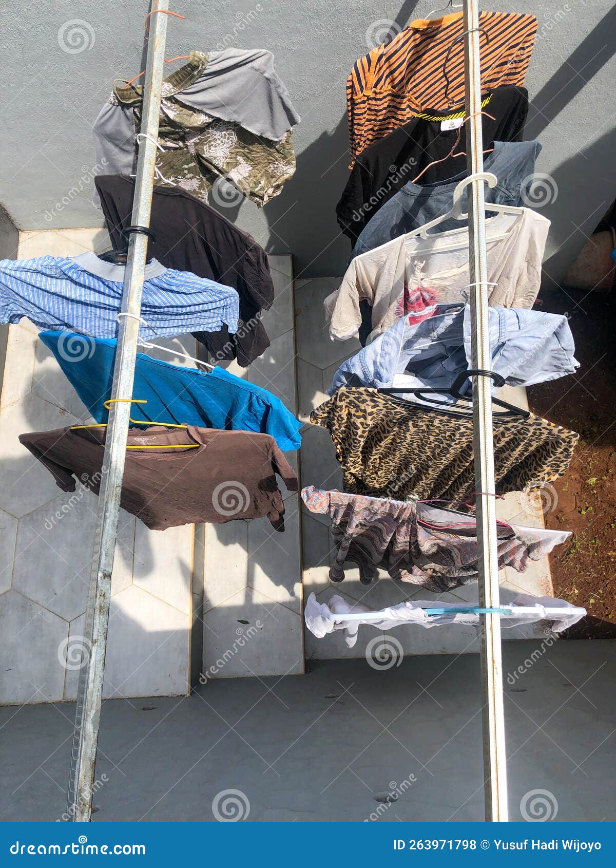 Drying clothes under sun stock photo. Image of bright 263971798