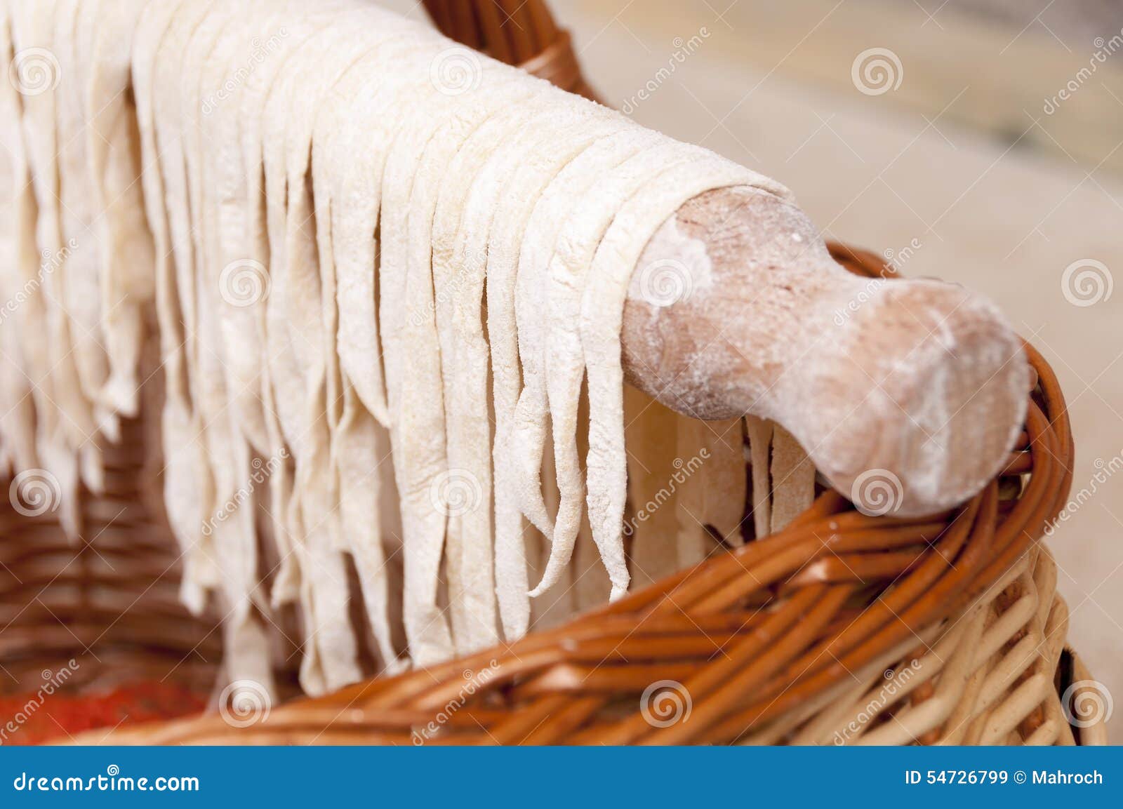 Drying homemade pasta on the wooden roller