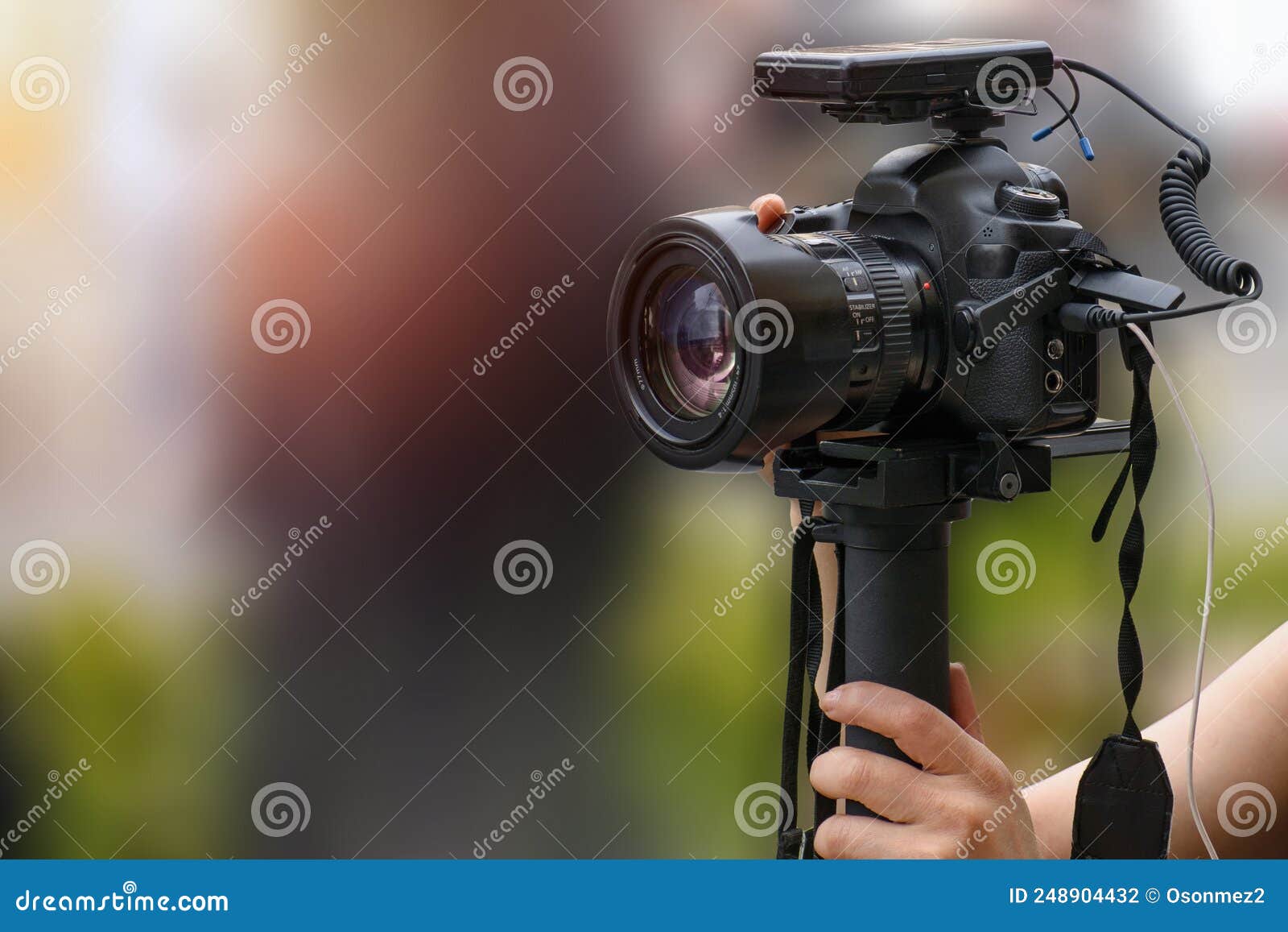dslr camera and microphone receiver used for video shooting on the street