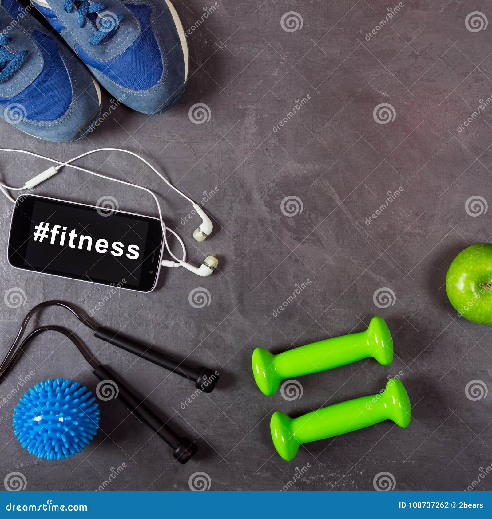 Dumbbell, Apple, Smartphone, Headphones and Sneakers on Grey Background. Hashtag  Fitness on the Smartphone Stock Photo - Image of media, equipment: 108737262