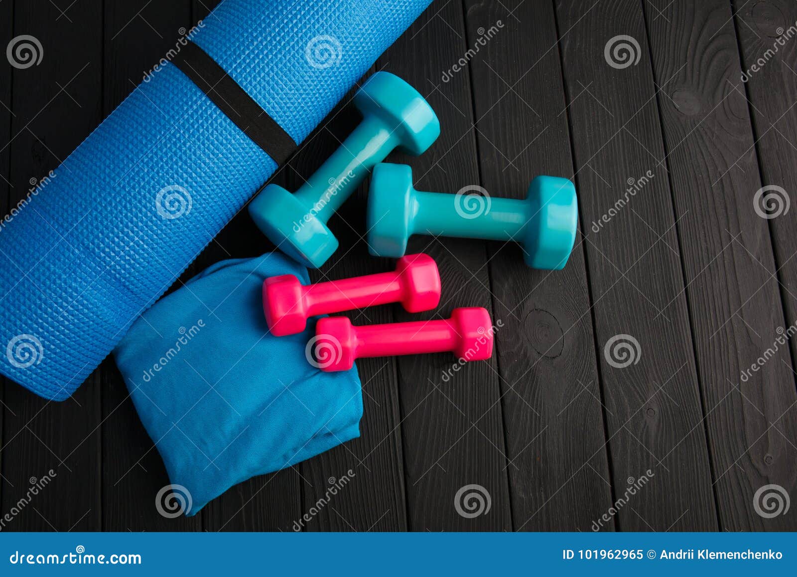 Dumbbells of Blue and Pink Plastic on a Brown Wooden Background. Stock ...