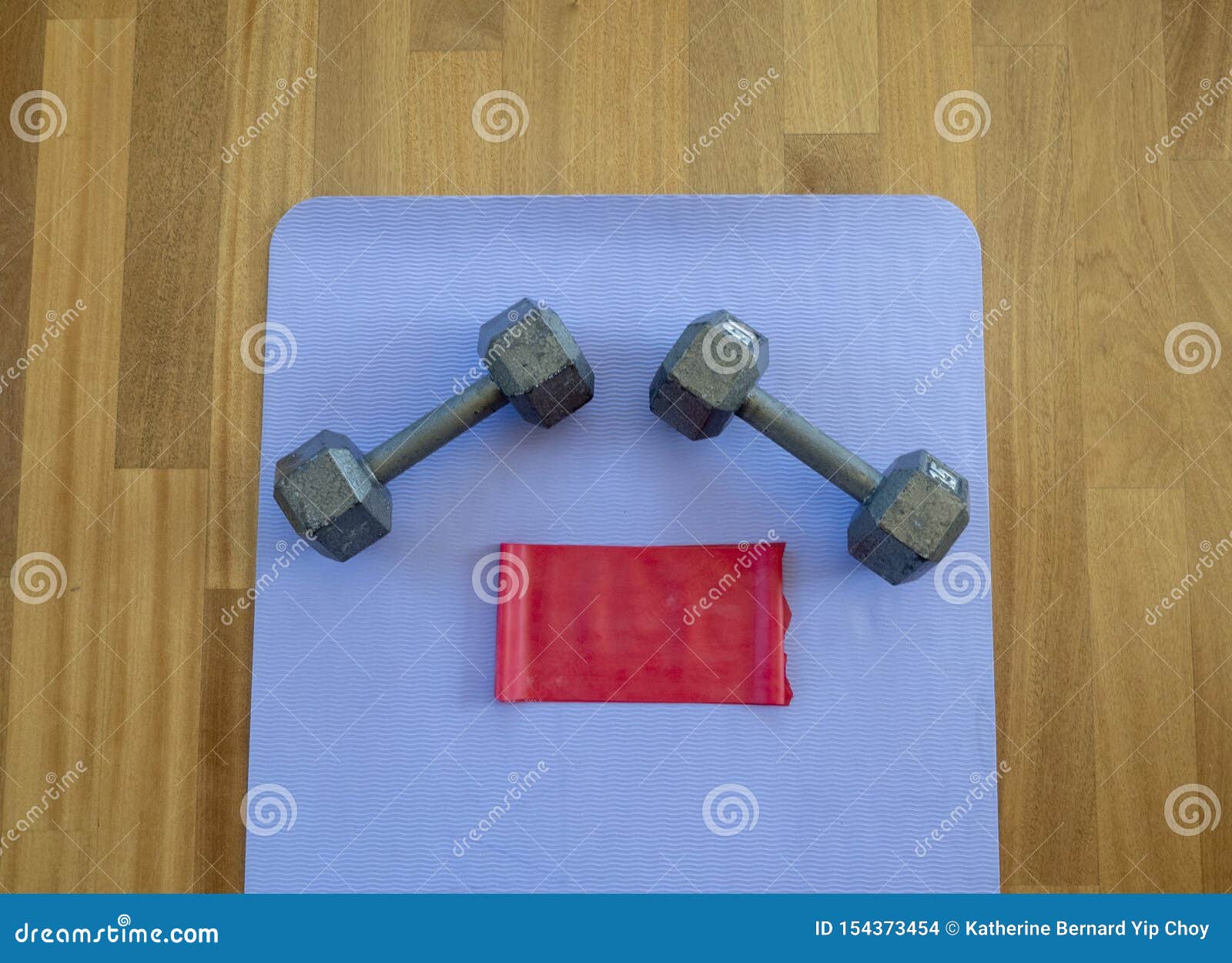 Dumbbells And Exercise Band On A Yoga Mat For A Home Workout Stock
