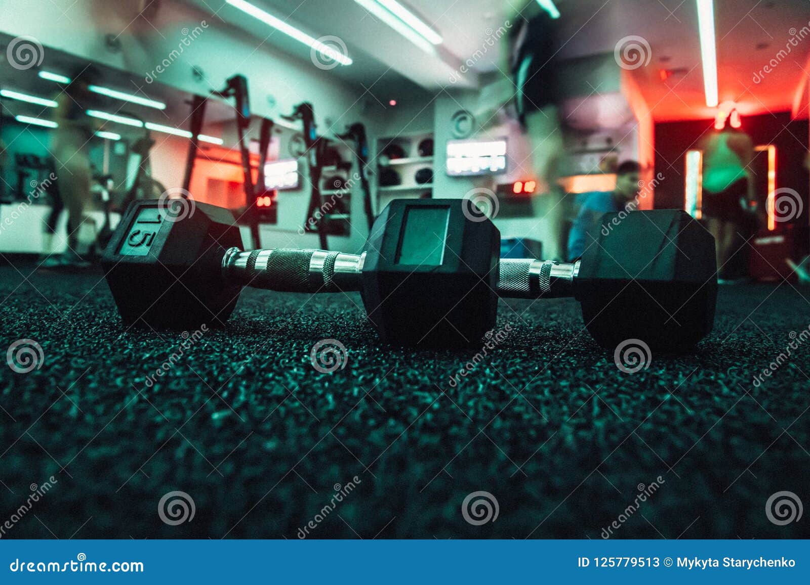Dumbbells in Gym with People Doing Sport Workout. Stock Image Image