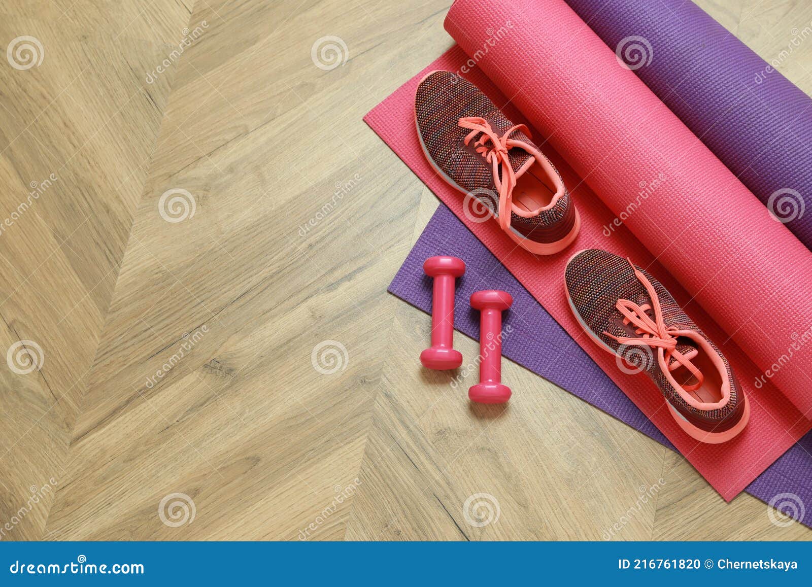 Dumbbells, Sneakers and Mats on Wooden Floor, Top View. Space for Text ...