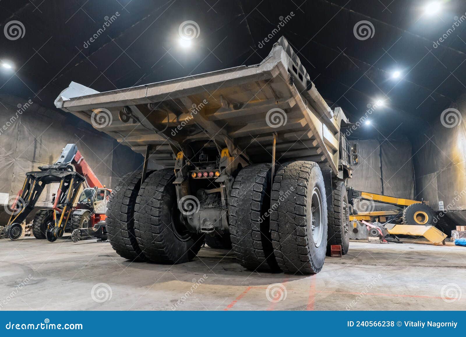 dump truck is serviced in an industrial garage.