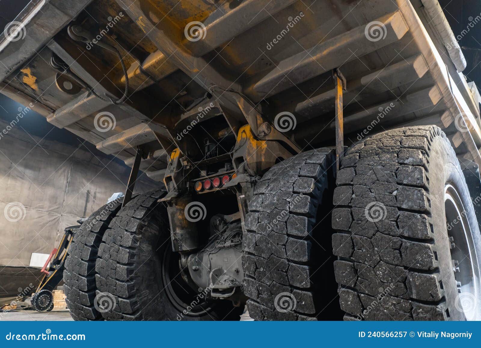 dump truck is serviced in an industrial garage.