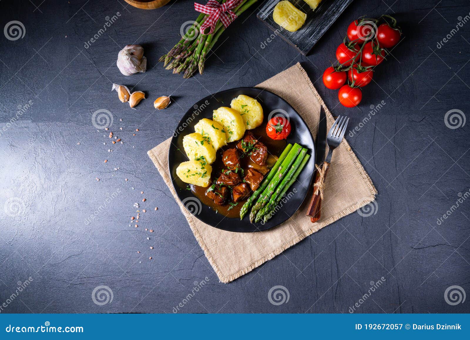 dumplings with beef goulash and green asparagus