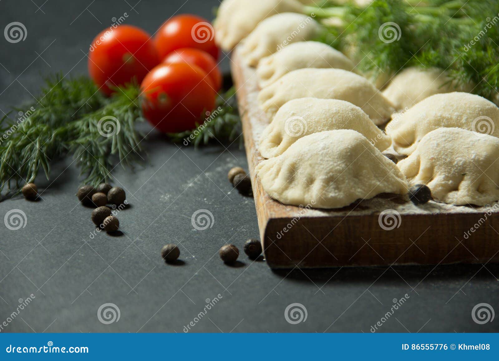 Dumplings on a Black Background with Fresh Herbs and Vegetables. Stock Photo Image of appetite