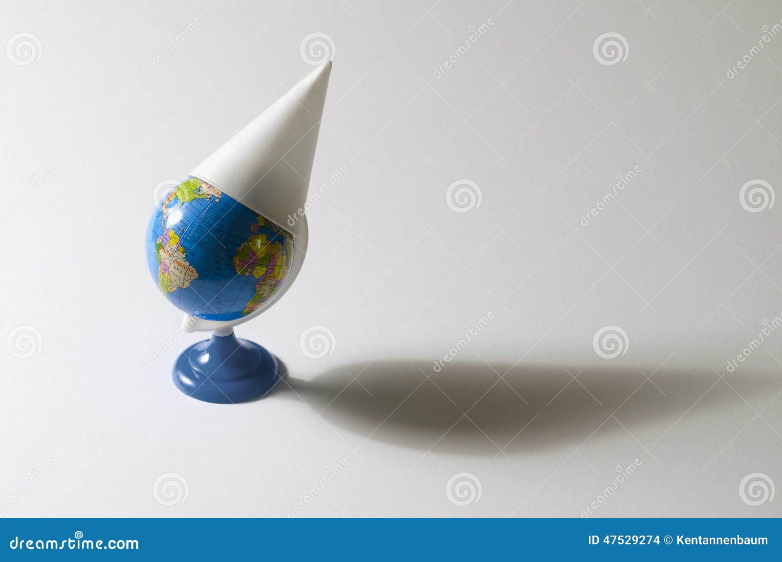 Dunce cap on toy globe earth model