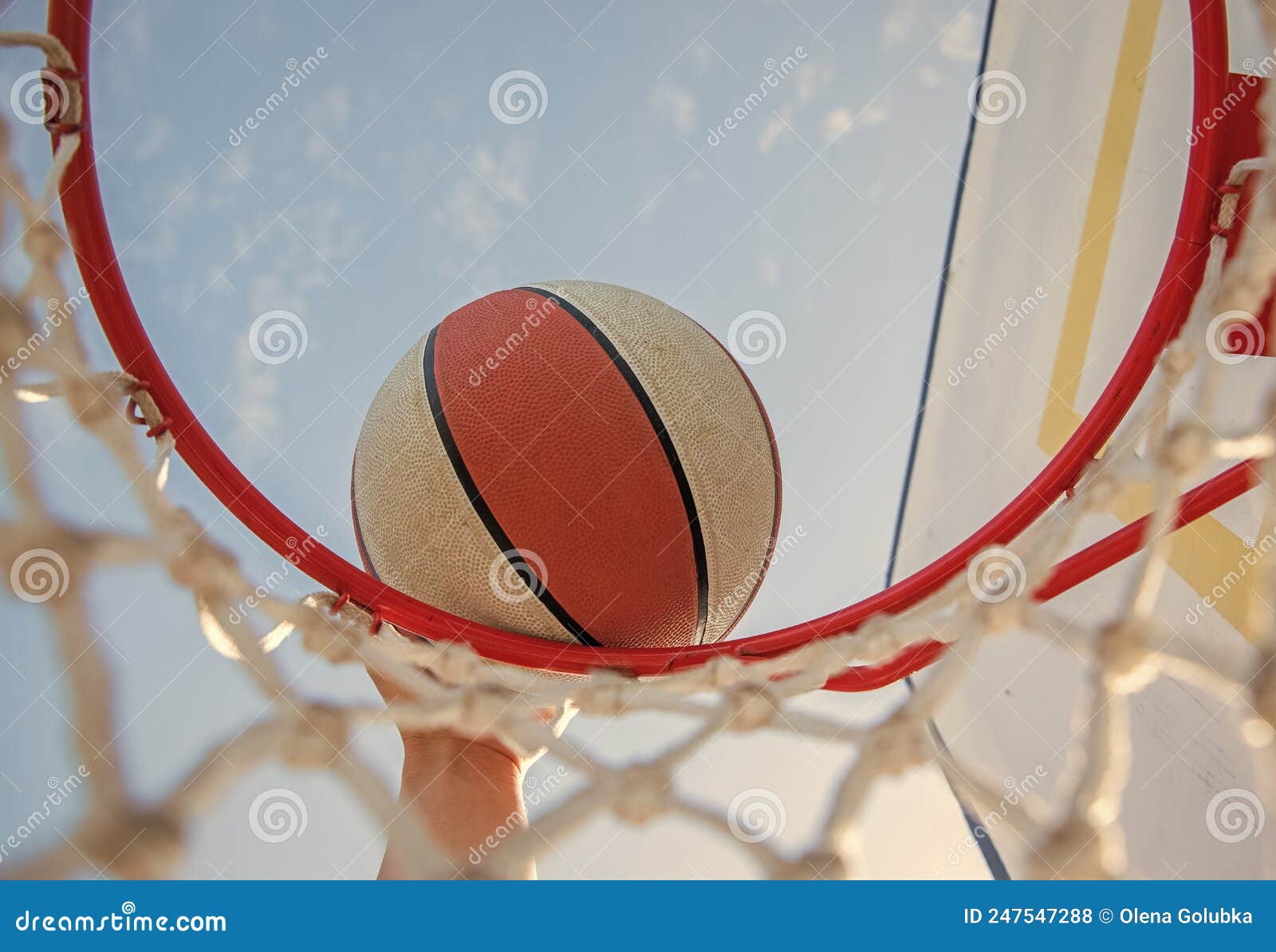 Dunking Basketball Ball through Net Ring with Hand, Basketball Stock