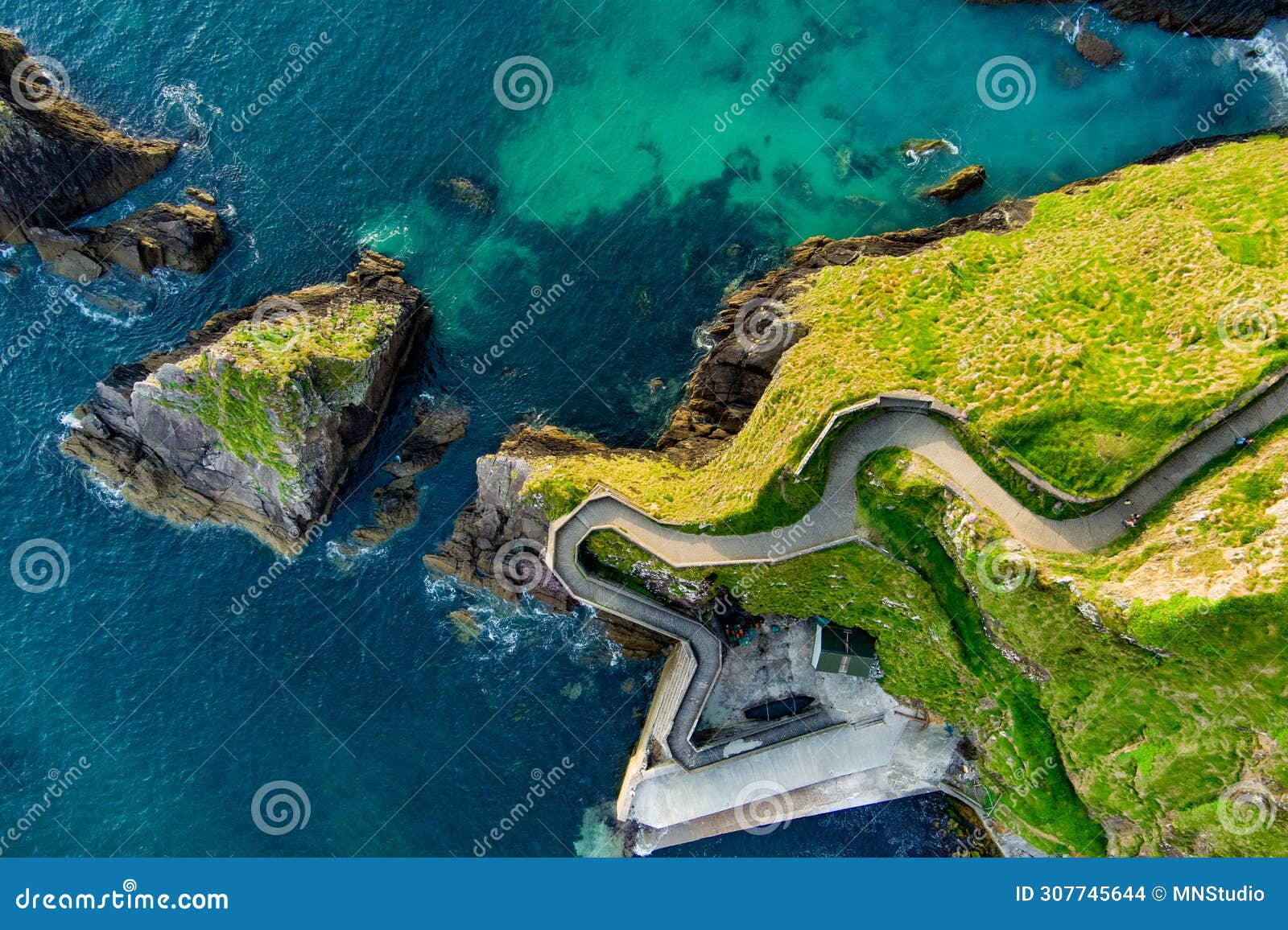 dunquin or dun chaoin pier, ireland's sheep highway. aerial view of narrow pathway winding down to the pier