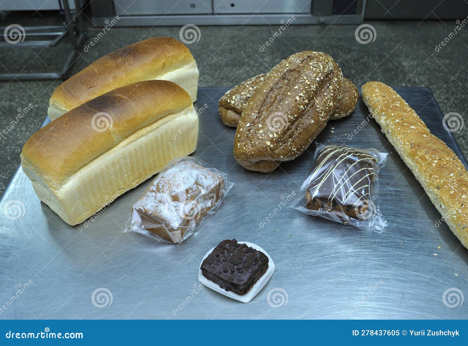 Dutch bakery products placed on a tray: bread, rolls, muffins.