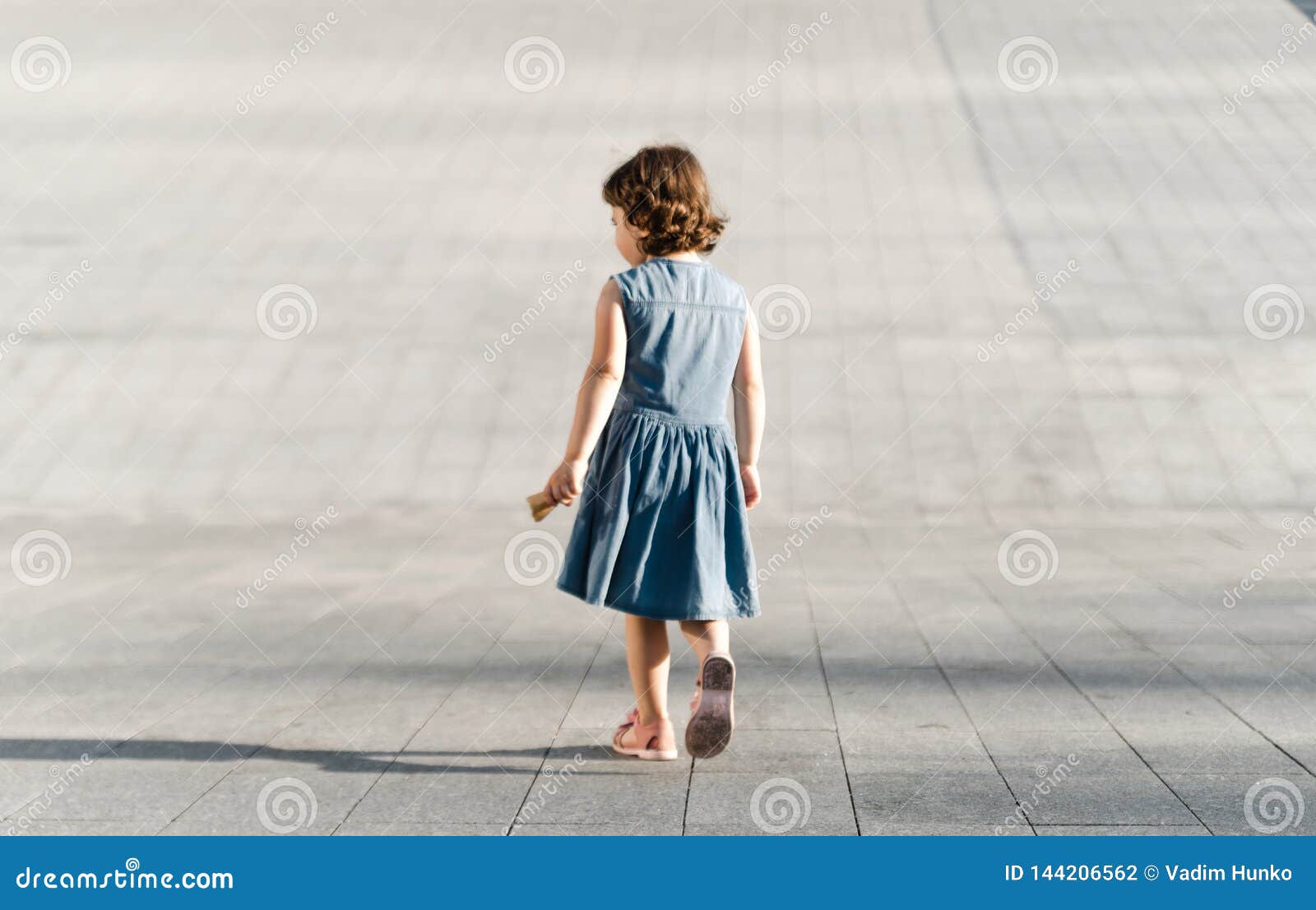 Childhood concept. Cute preschool girl is running. Little cute girl is running away and having fun. Childhood concept
