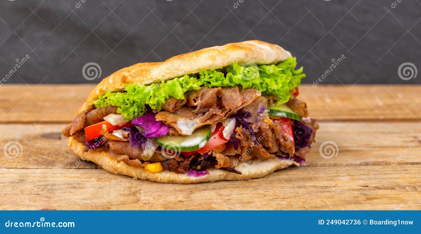 dÃÂ¶ner kebab doner kebap fast food in flatbread on a wooden board panorama