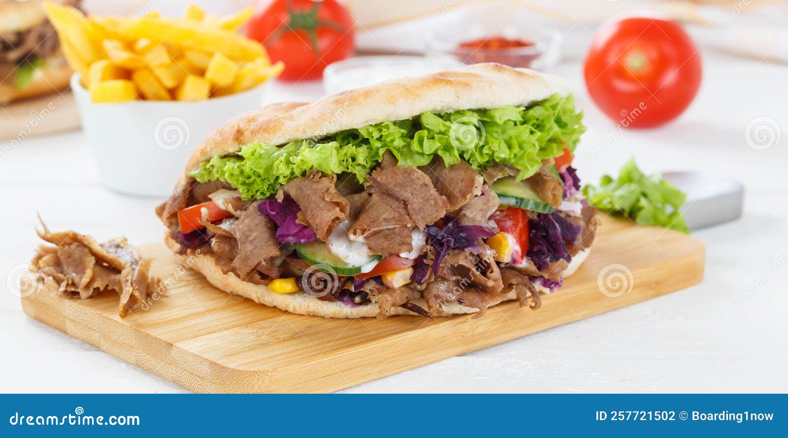 dÃÂ¶ner kebab doner kebap fast food meal in flatbread with fries on a kitchen board panorama