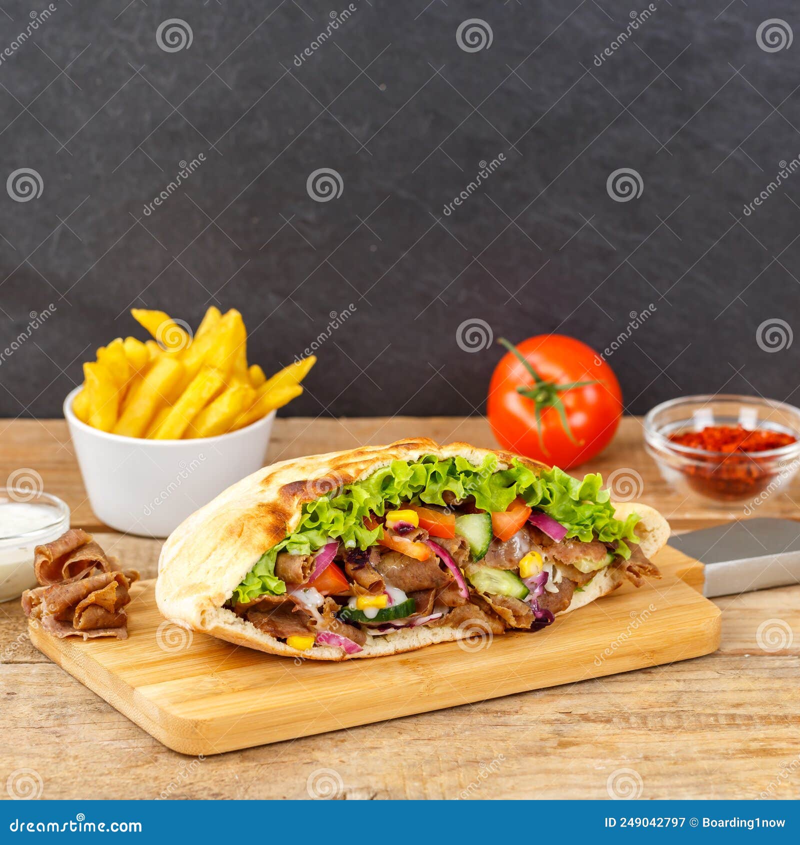 dÃÂ¶ner kebab doner kebap slice fast food in flatbread with french fries on a wooden board square